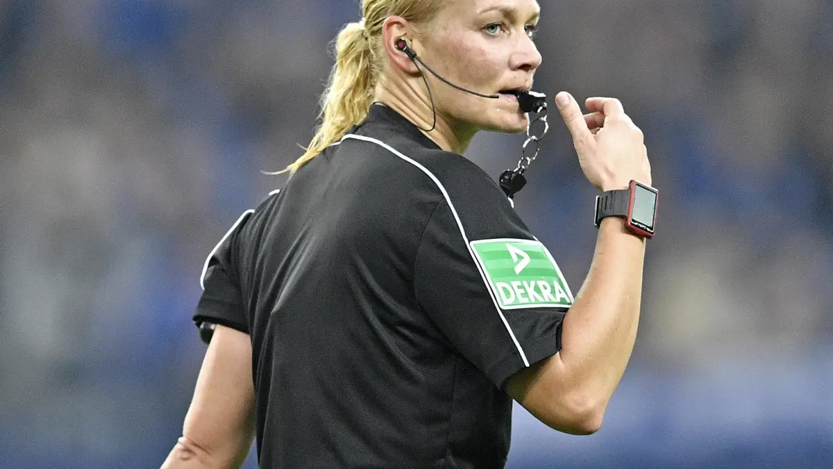 High school soccer referee showing a yellow card under new NFHS Soccer Rules 2026-27 protocol